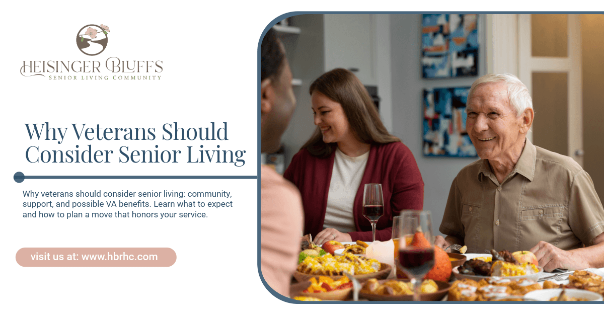 A veteran eating at a table while having conversations with other senior living residents